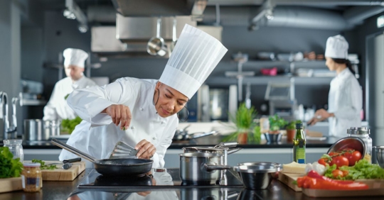 Female chef cooking food in a bright, organized kitchen
